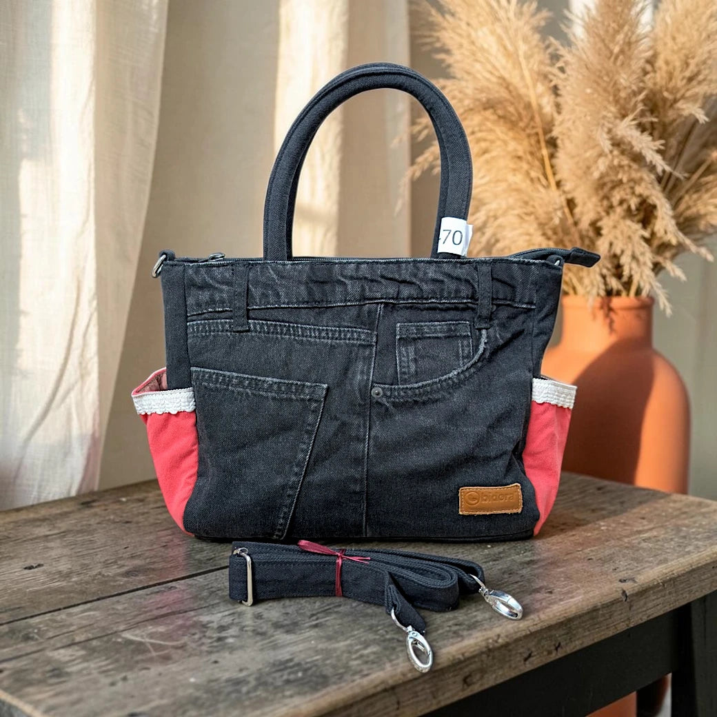 Bidora black upcycled denim tote handbag with red side panels, white lace trim, and a detachable shoulder strap.