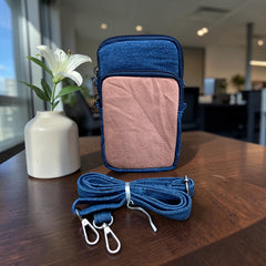 Bidora two-tone denim crossbody phone pouch with a detachable blue strap, featuring zippered compartments.