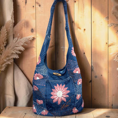 Bidora denim hobo shoulder bag with pink and white floral embroidery, stitching details, and a wooden toggle closure.
