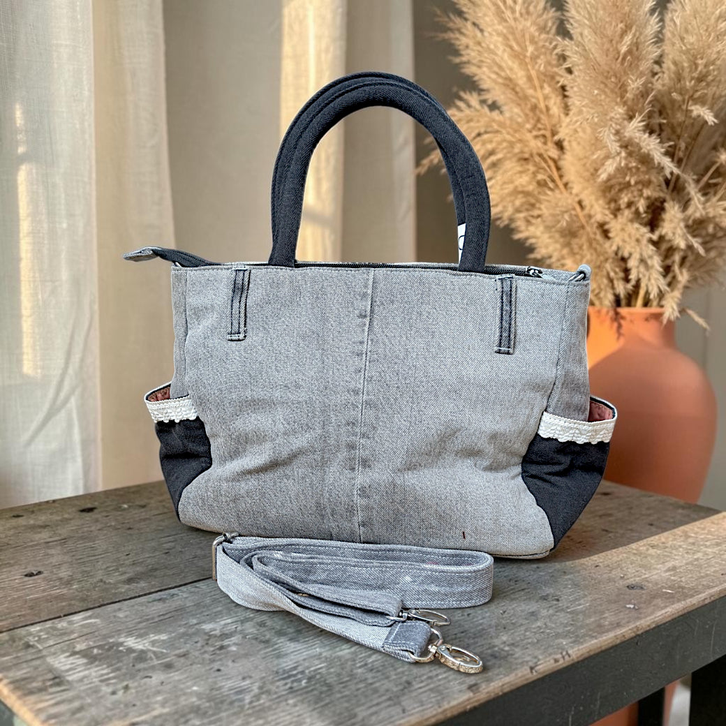 Bidora grey and black repurposed denim handbag with lace trim side pockets, top handles, and detachable strap
