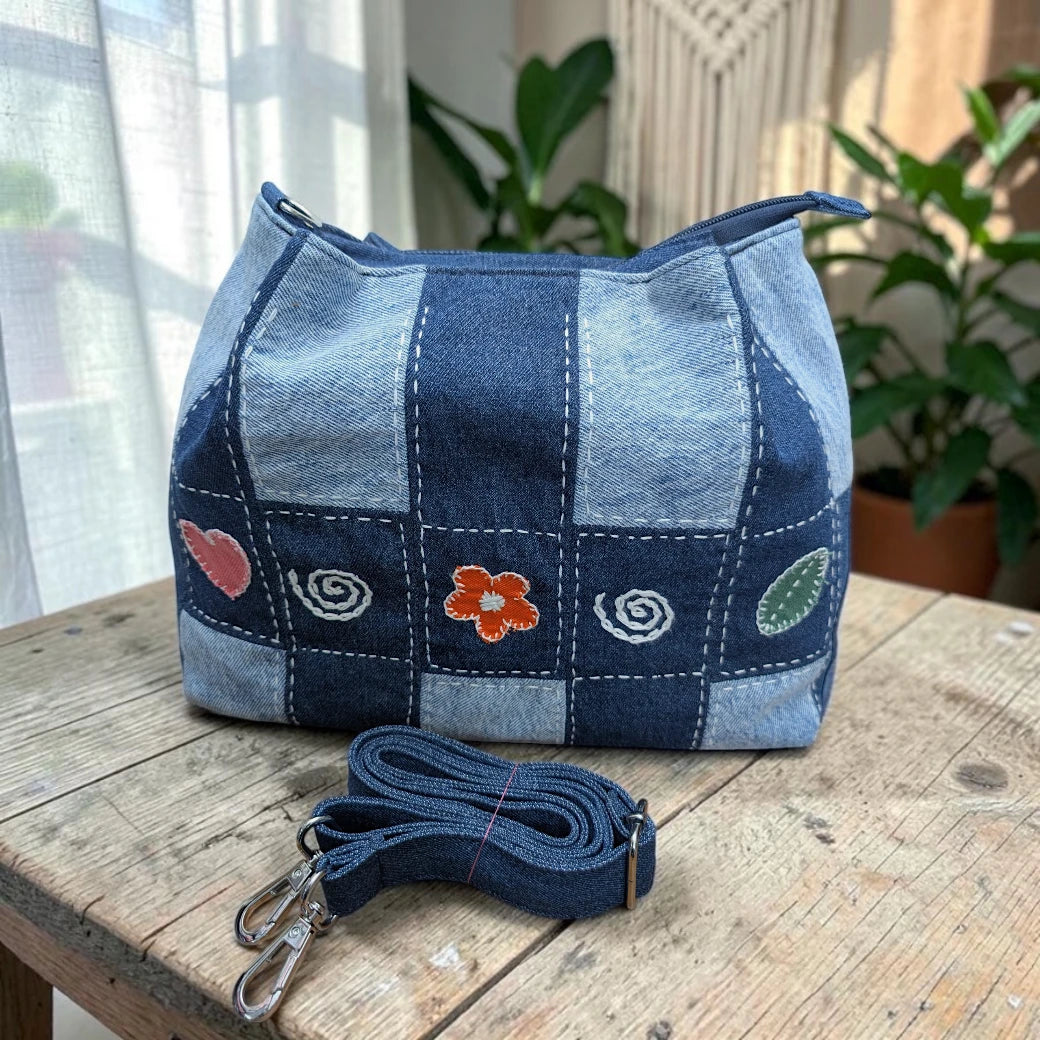 Bidora patchwork denim shoulder bag with checkerboard pattern, hand-stitched embroidery, and detachable strap.