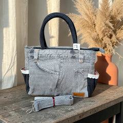 Bidora grey and black repurposed denim handbag with lace trim, top handles, and a detachable shoulder strap.