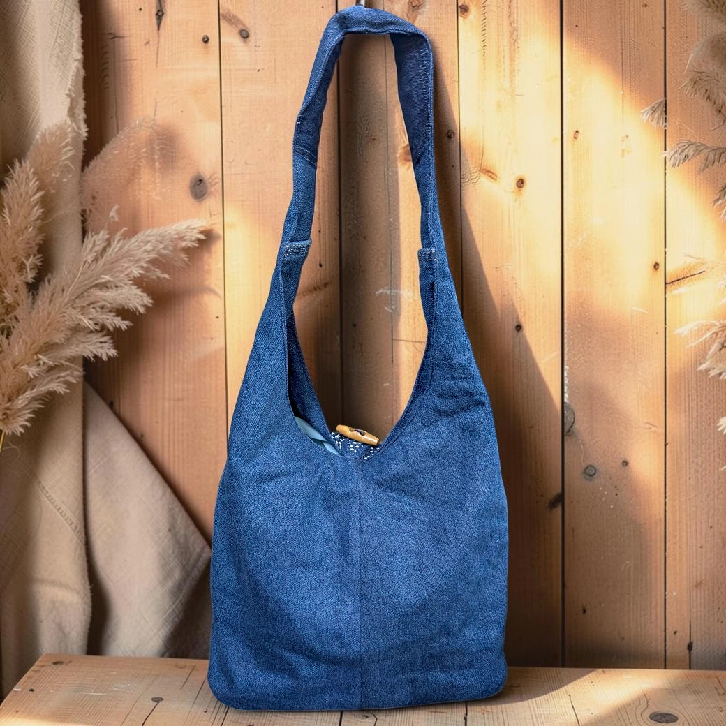 Bidora blue denim hobo shoulder bag with hand-stitched floral embroidery and a rustic wooden toggle closure