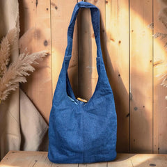 Bidora blue denim hobo shoulder bag with hand-stitched floral embroidery and a rustic wooden toggle closure