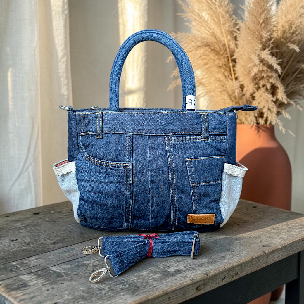 Bidora upcycled blue denim handbag with patchwork design, exterior pockets, sturdy handles, and detachable strap.