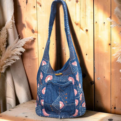 Bidora denim hobo shoulder bag with intricate floral embroidery, kantha stitching, and a wooden toggle closure.