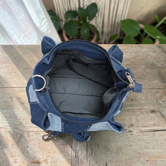 Bidora patchwork denim shoulder bag interior view showing grey lining and zippered closure on a wooden surface