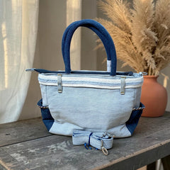 Bidora two-tone blue denim handbag with sturdy handles, side pockets, and a detachable adjustable shoulder strap.