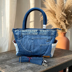 Bidora upcycled denim handbag with patchwork design, top handles, side pockets, and a detachable shoulder strap.