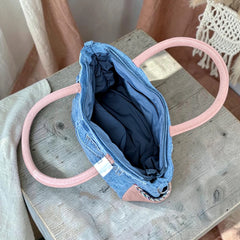 Bidora upcycled light-wash denim tote bag with pink handles and a spacious dark blue lined interior